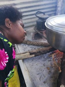 mary-keeping-the-fire-burning-when-making-mango-chutney-in-vanuatu