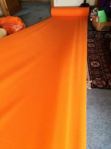 orange-fabric-on-floor-ready-for-cutting